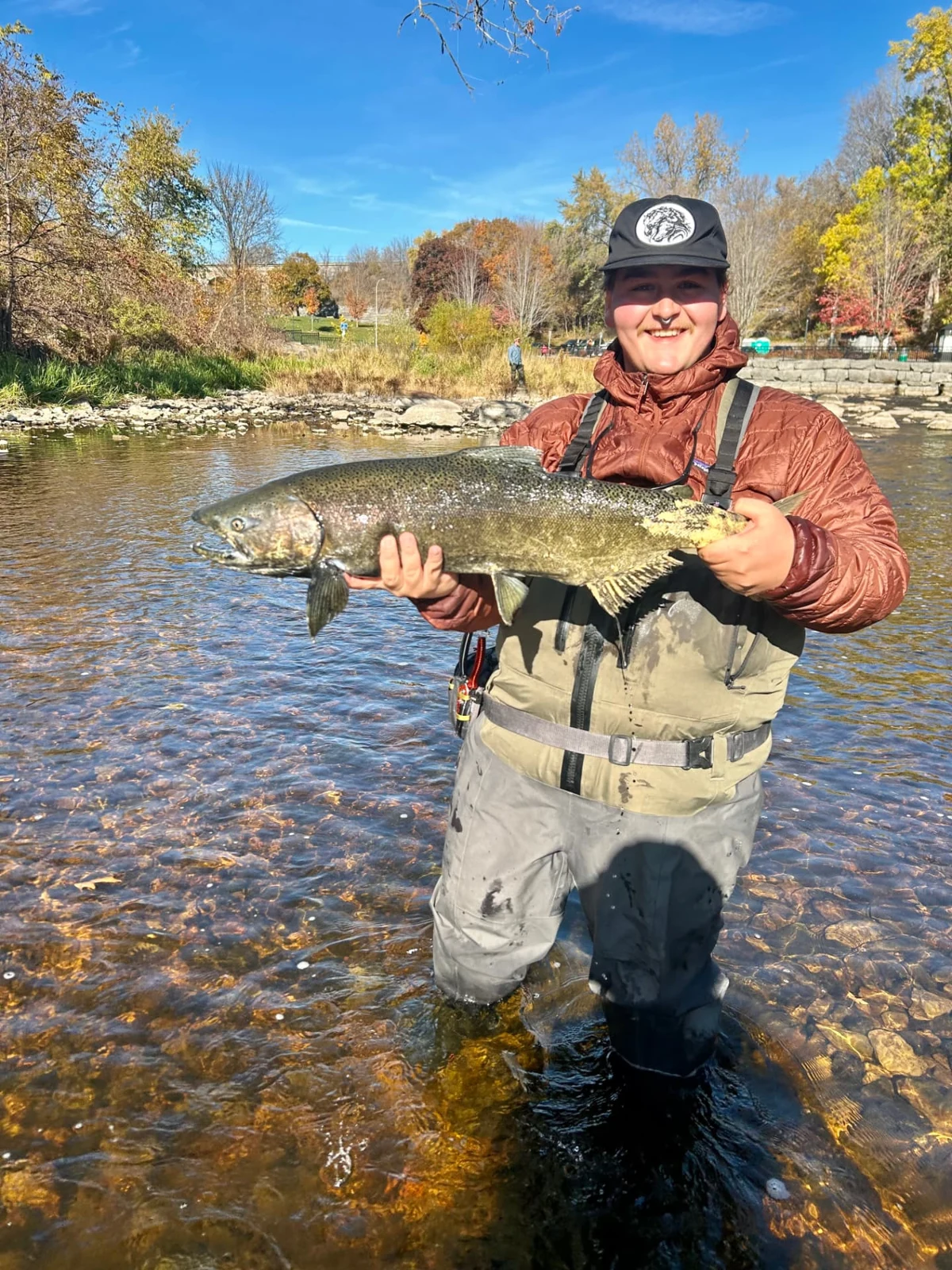 An angler holding a Chinook salmon in Kingston on October 25, 2026.